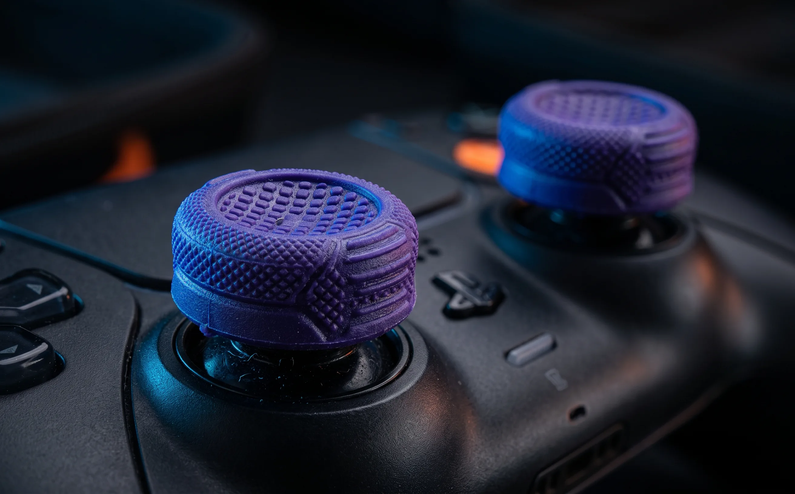 Close-up of purple textured thumbstick grip attachments on a gaming controller, dramatic macro lighting